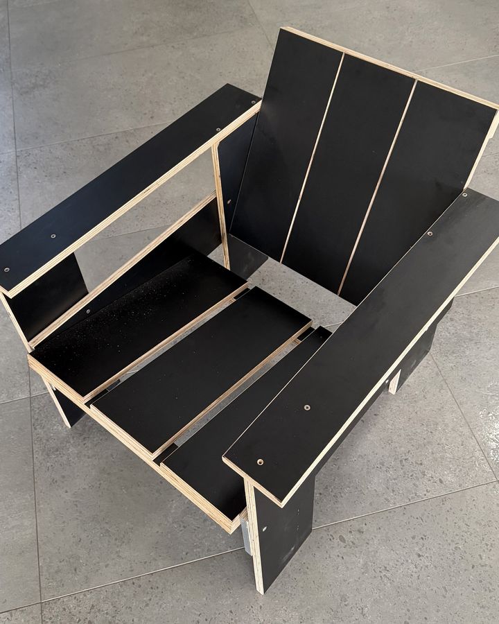 The ten-dollar replica in black film-faced plywood with the wide 100 mm arms, 2026